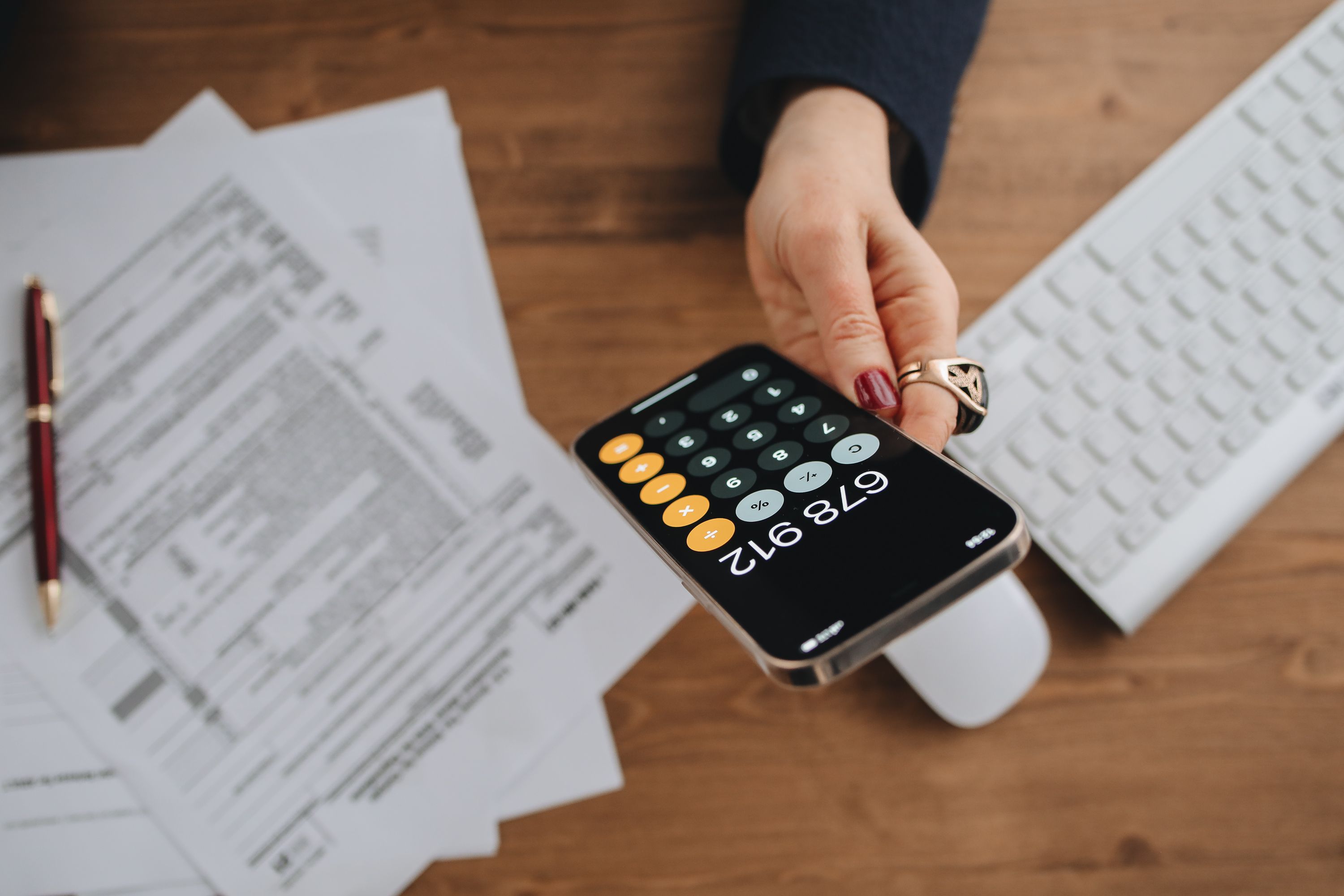 A property manager totalling monthly revenue at a desk