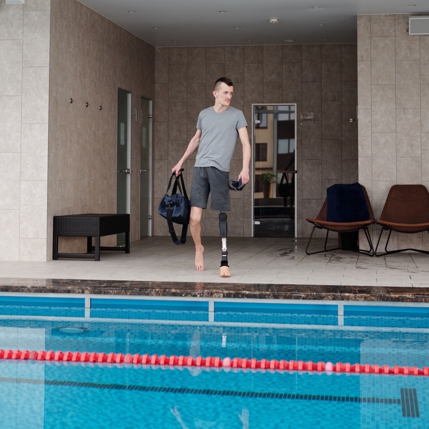 A gym member swimming lengths in the facility pool